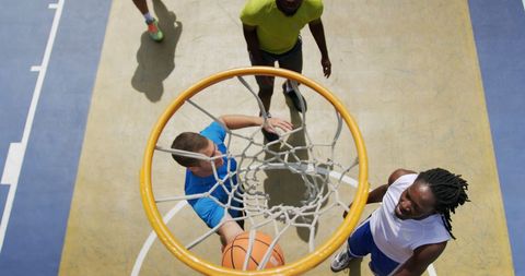 Diverse Group of Male Basketball Players Practicing on Court
