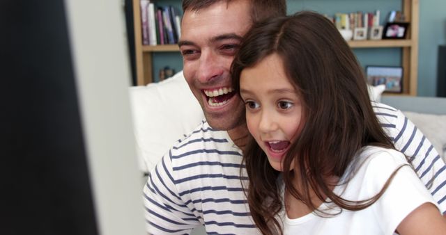 Excited Father and Daughter Watching Screen Together - Download Free Stock Images Pikwizard.com