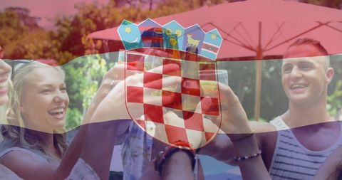 Joyful croatian reunion celebrating with drinks outdoors