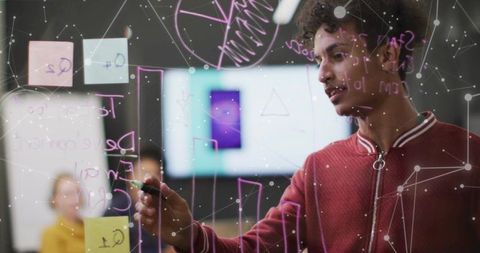 Developer collaborating on glass board in modern office