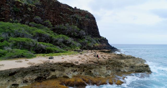 Solitary Traveler Exploring Rocky Shoreline of Tropical Island - Download Free Stock Images Pikwizard.com