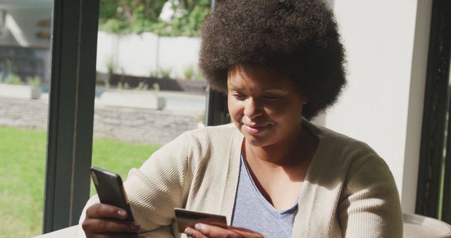 Smiling Afro-American Woman Using Smartphone and Credit Card for Online Shopping - Download Free Stock Images Pikwizard.com