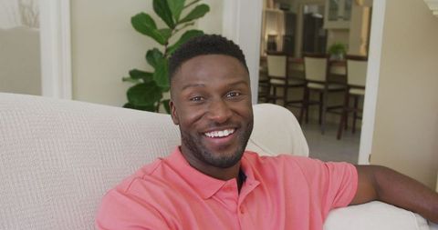 Smiling African American Man Relaxing in Modern Living Room