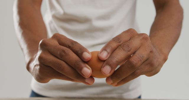 Close-Up of Person Cracking Brown Egg on Counter - Download Free Stock Images Pikwizard.com