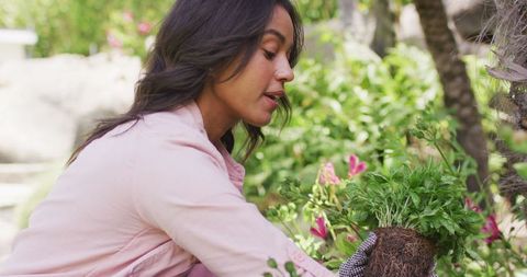 Young Woman Planting Flowers in Garden Simplistic Approach - Download Free Stock Images Pikwizard.com