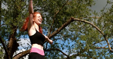 Joyful Redhead Celebrating Outdoor Fitness Success