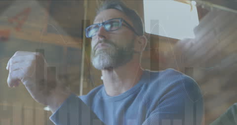 Contemplative Man Analyzing Financial Data on Laptop