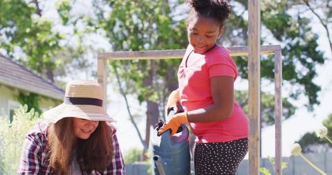 Mother and Daughter Enjoy Gardening on Sunny Day
