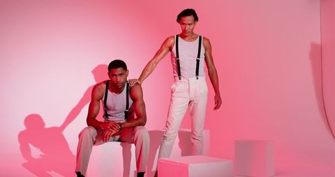 Stylish Male Models in Contemporary Fashion with Pink Lighting