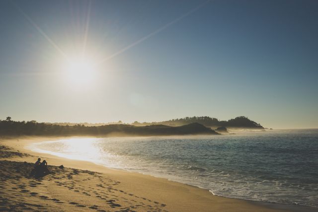 Idyllic Beach with Golden Sun Setting over Shoreline - Download Free Stock Photos Pikwizard.com