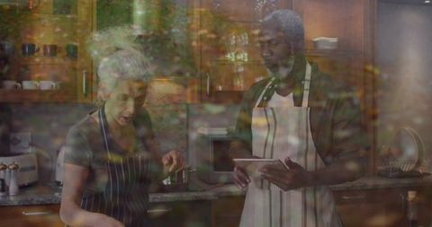 Cooking Together: Mature Couple Using Tablet for Recipe Guidance in Cozy Home Kitchen