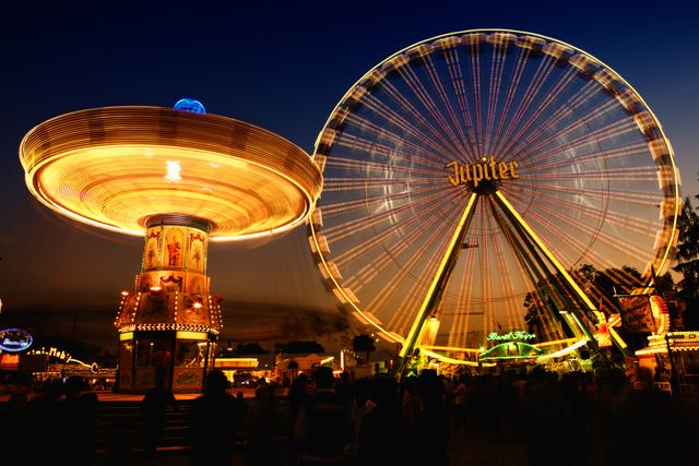 Brightly Lit Amusement Park at Night with Ferris Wheel and Carousel - Download Free Stock Photos Pikwizard.com