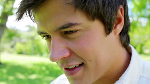 Young Man Relaxing in Lush Countryside Setting