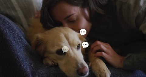 Cuddling woman pressing cheek to golden dog on couch conveying warm pet companionship intimate close