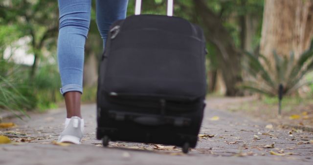 Traveler Pulling Suitcase Outdoors on Path - Download Free Stock Images Pikwizard.com