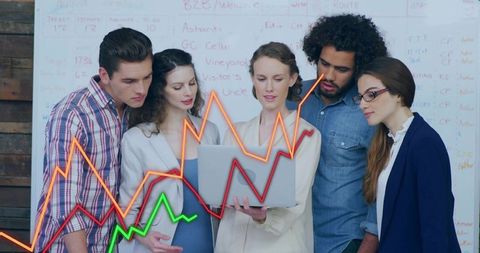 Coworkers brainstorming over data in modern workspace