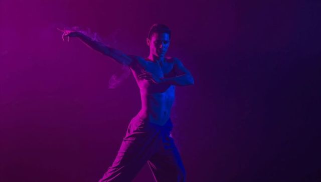 Shirtless male dancer posing in dynamic lighting effect