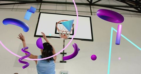 Jumping athlete reaching basketball hoop with neon 3d geometric overlays in gymnasium