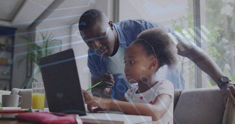 Father guiding daughter using laptop for remote learning, homework help and family tutoring