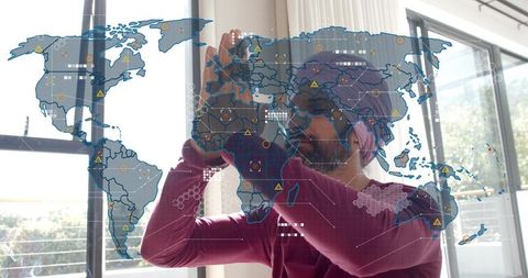 Indian man in turban manipulating augmented reality world map with holographic overlay, gesture