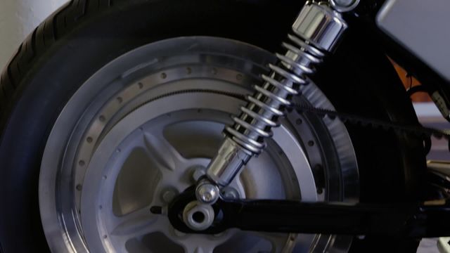 Animation showcases a close-up of a motorbike wheel with a running engine. Ideal for illustrating mechanics, vehicle engineering or technology. Can be used in videos about motorbike maintenance, engineering tutorials or automotive advertisements.