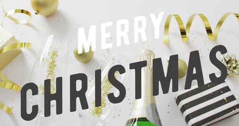 Merry christmas party flat-lay celebrating champagne bottle, flutes, gold baubles, ribbon