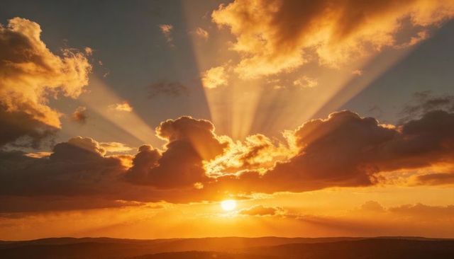 Golden Sunbeams Breaking Through Cloudbank Over Rolling Hills at Dramatic Sunset
