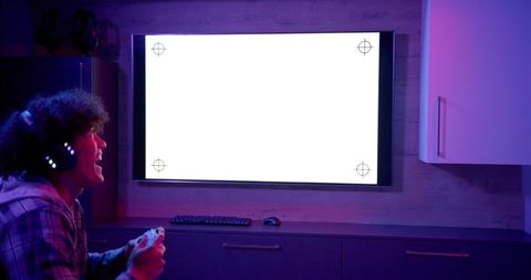 Gamer engaged with blank tv screen in home entertainment setup