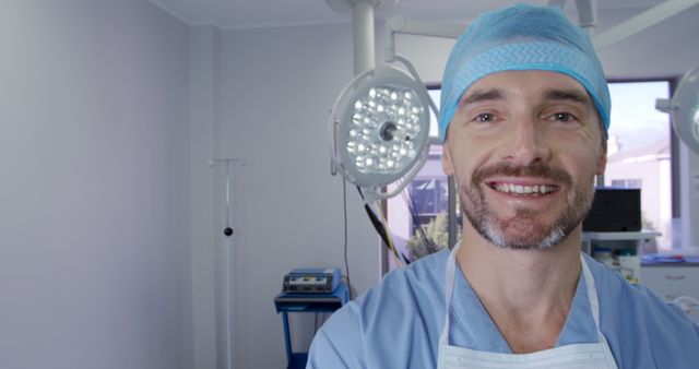 Smiling Surgeon in Operating Room with Surgical Lights - Download Free Stock Images Pikwizard.com