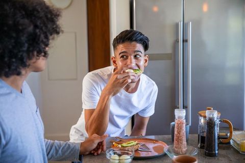 Diverse Friends Enjoying Avocado Toast at Home Kitchen