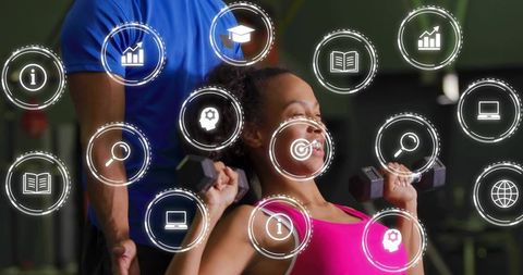 Woman doing dumbbell bench press with trainer spotting and futuristic fitness hud