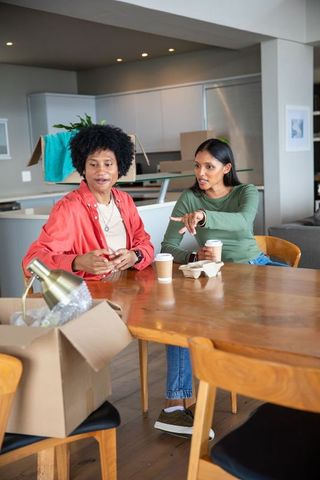 Couple enjoying coffee break during home relocation