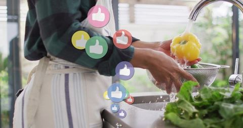 Woman rinsing yellow bell pepper at kitchen sink with social likes overlay for healthy meal prep