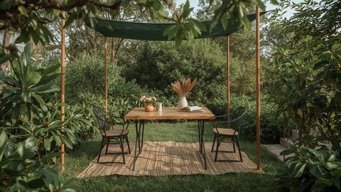 Rustic Outdoor Setup with Table and Chairs in Lush Garden
