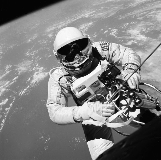 S65-32928 (3 June 1965) --- Astronaut Edward H. White II, pilot of the Gemini IV four-day Earth-orbital mission, floats in the zero gravity of space outside the Gemini IV spacecraft. White wears a specially designed spacesuit; and the visor of the helmet is gold plated to protect him against the unfiltered rays of the sun. He wears an emergency oxygen pack, also. He is secured to the spacecraft by a 25-feet umbilical line and a 23-feet tether line, both wrapped in gold tape to form one cord. In his left hand is a Hand-Held Self-Maneuvering Unit (HHSMU) with which he controls his movements in space. Astronaut James A. McDivitt, command pilot of the mission, remained inside the spacecraft. (This image is black and white) Photo credit: NASA    EDITOR'S NOTE: Astronaut White died in the Apollo/Saturn 204 fire at Cape Kennedy on Jan. 27, 1967.