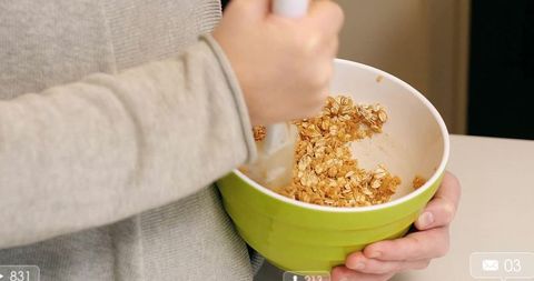 Woman preparing oatmeal in modern kitchen at home