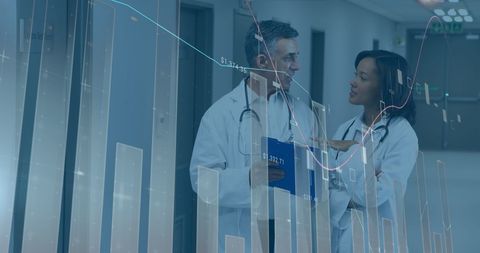 Doctors Analyzing Financial Growth Insights in Hospital Corridor