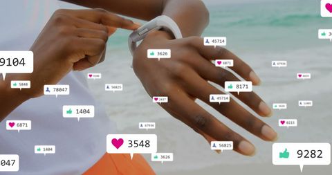 Hand with Smartwatch on Beach Featuring Social Media Interaction