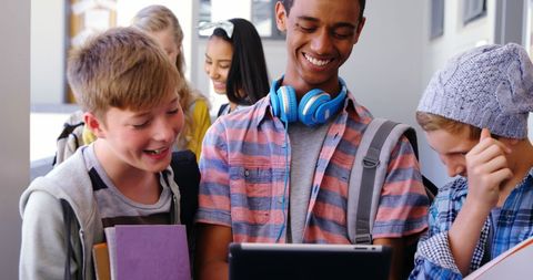 Diverse Group of Students Enjoying Tablet In School Corridor - Download Free Stock Images Pikwizard.com