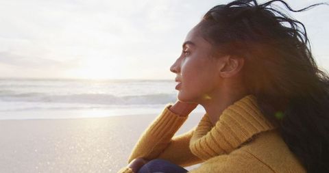 Contemplative Woman Enjoying Scenic Beach Sunset - Download Free Stock Images Pikwizard.com