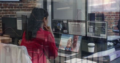 Businesswoman Analyzing Data and Having Video Call in Modern Office