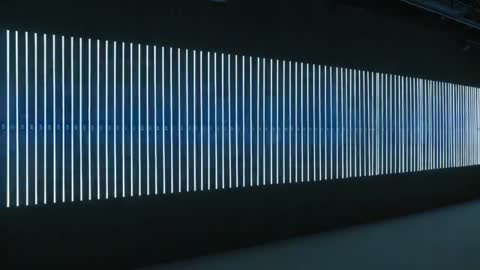Shifting Vertical LED Bars Pulsing Cyan Band Along Gallery Corridor Looping Light Installation