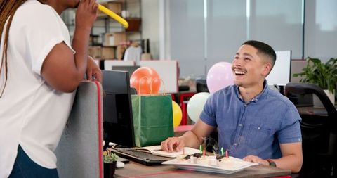 Office birthday celebration with cake and gifts