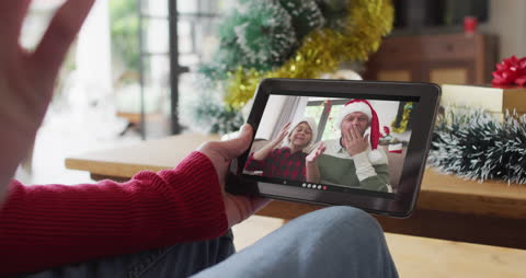 Joyful Virtual Christmas Call with Family on Tablet
