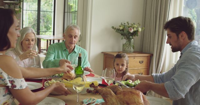 Family Enjoying Holiday Meal Together Around Dining Table - Download Free Stock Images Pikwizard.com