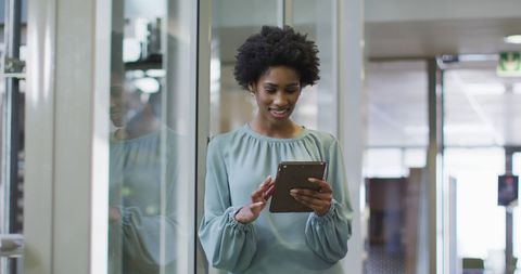 Confident African American Businesswoman Using Tablet Technology in Modern Office