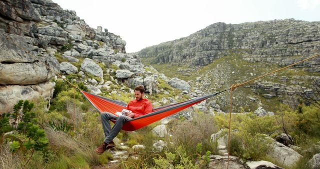 Man Resting in Hammock Amidst Mountainous Terrain - Download Free Stock Images Pikwizard.com