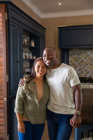 Smiling Couple Hugging in Contemporary Kitchen Setting