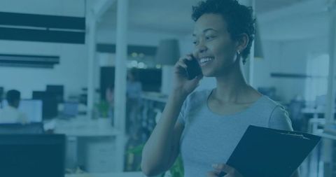 Confident Professional Woman Holding Clipboard on Phone in Office