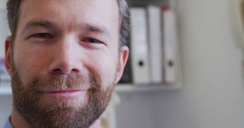 Smiling Caucasian Male Doctor in Medical Office